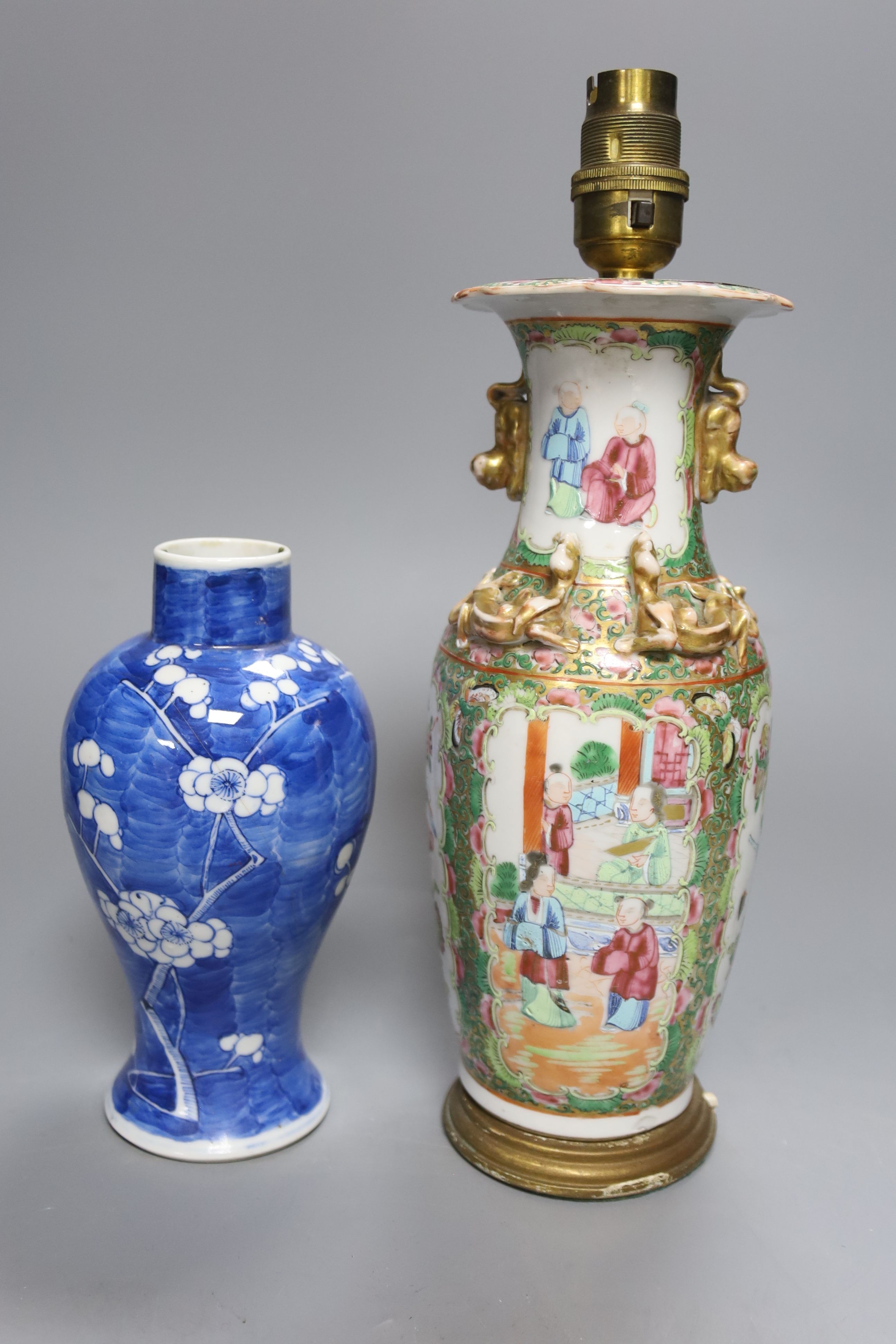 A Chinese famille rose converted lamp, a similar blue and white vase and another vase and cover, overall height 32cm